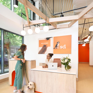 Small Door front desk where member is chatting with recepcionist.